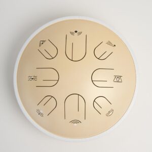 Moon Tone 12.5-inch steel tongue drum in Warm Sky Cream, top view showing eight tongues