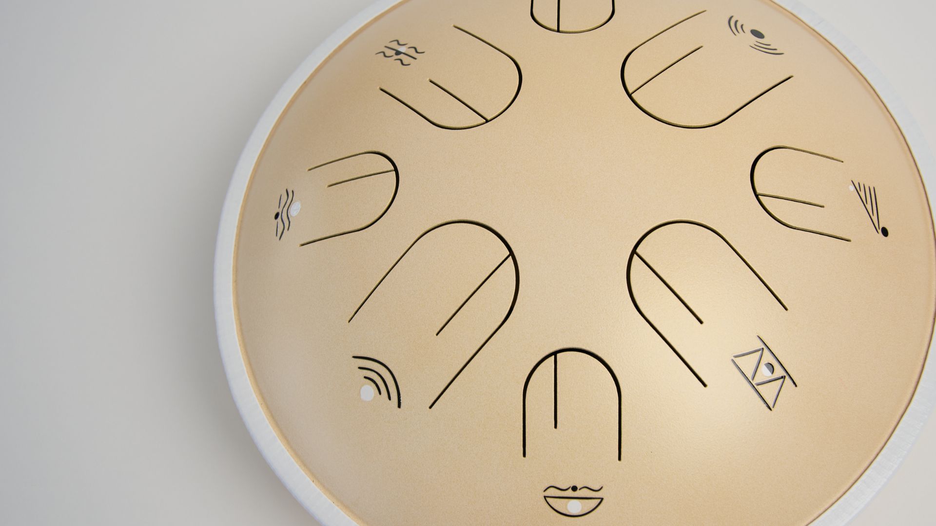 Close-up of the tongues on a cream-colored Moon Tone steel tongue drum